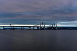 New and Old Tappan Zee Bridges coexisting across Hudson River with a dramatic sunset. photo