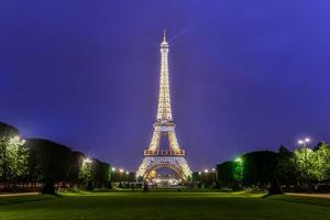 The iconic Eiffel Tower on a drizzly evening from the Champ de Mars in Paris, France, 2022 photo