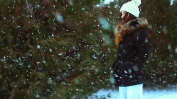 Young girl in winter outside in a snowstorm posing video