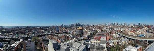 Brooklyn, New York - Apr 8, 2021 -  Water tower and a view of the Manhattan Skyline in the background. photo