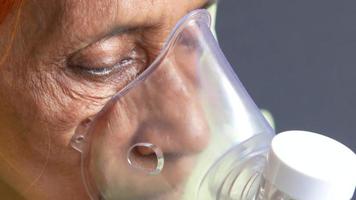 senior women using nebulizer close up