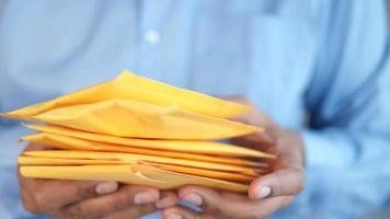 mão segure envelope de bolha de papel amarelo video