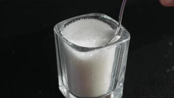 Close up view of white sugar on spoon video