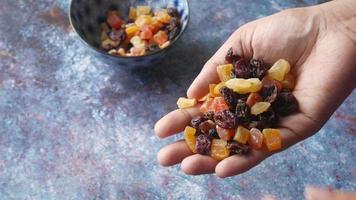 Dried fruits and berries on blue background video