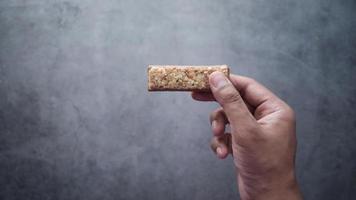 Slow motion of hands breaking a sweet peanuts bar video