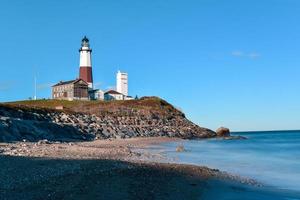 The Montauk Point Lighthouse located adjacent to Montauk Point State Park, at the easternmost point of Long Island, in the hamlet of Montauk in the Town of East Hampton in Suffolk County, New York. photo