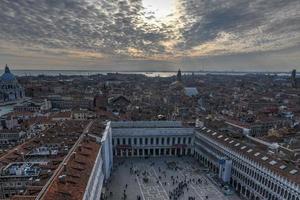 Aerial view of Saint Marks Square in Venice Italy. It is the principal public square of Venice, Italy, where it is generally known just as la Piazza. photo