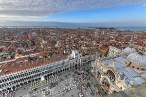 Aerial view of Saint Marks Square in Venice Italy. It is the principal public square of Venice, Italy, where it is generally known just as la Piazza. photo