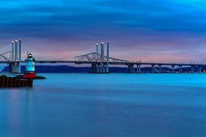 New and Old Tappan Zee Bridges coexisting across Hudson River with a dramatic sunset. photo