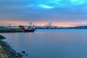 New and Old Tappan Zee Bridges coexisting across Hudson River with a dramatic sunset. photo