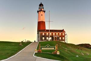 The Montauk Point Lighthouse located adjacent to Montauk Point State Park, at the easternmost point of Long Island, in the hamlet of Montauk in the Town of East Hampton in Suffolk County, New York. photo