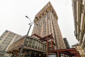 Milan, Italy - March 18, 2018 -  Torre Velasca is a skyscraper built in 1958, first 18 floors shops and offices and the subsequent to 26th are apartments, in Velasca square, Milan, Italy. photo