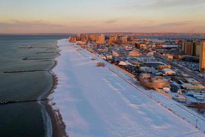 Aerial view of a snow covered Coney Island Beach during the winter at sunrise in Brooklyn, New York photo