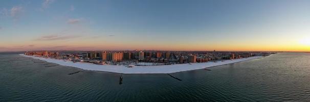 Aerial view of a snow covered Coney Island Beach during the winter at sunrise in Brooklyn, New York photo