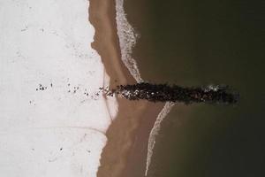 Aerial view of a snow covered Coney Island Beach during the winter at sunset in Brooklyn, New York photo