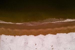 Aerial view of a snow covered Coney Island Beach during the winter at sunset in Brooklyn, New York photo