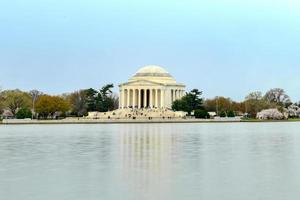 Cherry blossoms at the Tidal Basin and Jefferson Memorial during spring in Washington, DC. photo