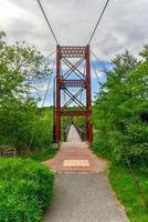The Androscoggin Swinging Bridge is a pedestrian suspension bridge spanning the Androscoggin River between the Topsham Heights neighborhood of Topsham, Maine and neighboring Brunswick. photo