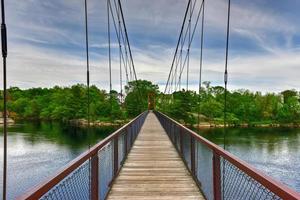 The Androscoggin Swinging Bridge is a pedestrian suspension bridge spanning the Androscoggin River between the Topsham Heights neighborhood of Topsham, Maine and neighboring Brunswick. photo