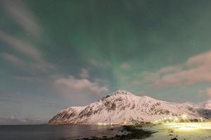 aurora boreal sobre el mar en vareid, islas lofoten, noruega en el invierno. foto