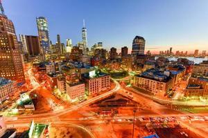 The skyline of downtown Manhattan, New York at sunset with trails of traffic in the street. photo