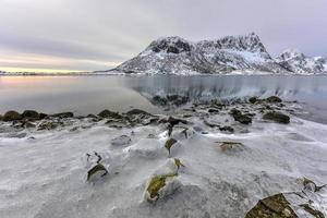 Vagspollen reflection at sunrise in the Lofoten Islands, Norway in the winter. photo