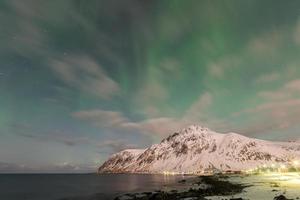 Northern lights over the sea at Vareid, Lofoten Islands, Norway in the winter. photo