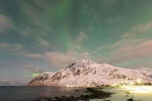 Northern lights over the sea at Vareid, Lofoten Islands, Norway in the winter. photo