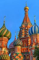 Domes of the Cathedral of Vasily the Blessed against a blue sky in Red Square in Moscow, Russia photo