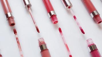 Clean artistic layout of open liquid lipsticks on white background for commercial use video