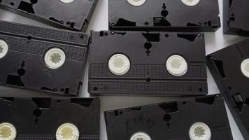 Woman stacking VHS cassette tapes one at a time video