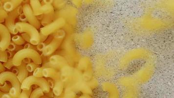 Pasta being poured and slowly filling up screen video