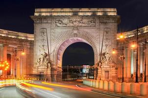 Traffic flowing through the Manhattan Bridge Arch and Colonnade Entrance in New York, USA photo