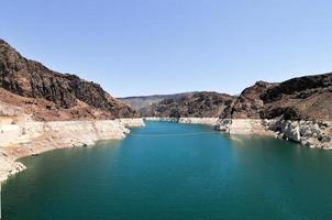 Hoover Dam, originally known as Boulder Dam, a concrete arch-gravity dam in the Black Canyon of the Colorado River, on the border between the U.S. states of Nevada and Arizona. photo