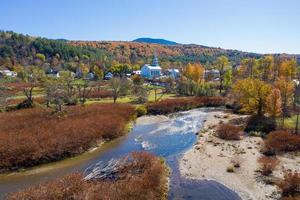 Stowe panorama in late Autumn with colorful foliage and community church in Vermont. photo