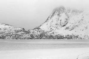 Storvatnet Lake in front of the landscape of the Lofoten mountains on the island Flakstadoy in the winter. photo