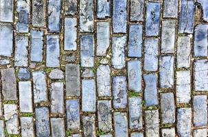 Blue cobblestone paved street in Old San Juan, Puerto Rico. They were brought as ballast in the bottoms of European merchant ships in the 1700s. photo