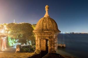 Lookout Tower along the walls of Old San Juan, Puerto Rico from Plaza de la Rogativa with a view of the San Juan Gate. photo