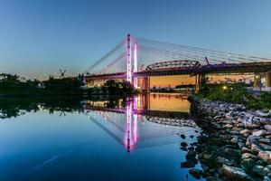 New and old Kosciuszko bridges joining Brooklyn and Queens in New York City across Newtown Creek. The new bridge is a cable-stayed bridge while the old bridge from 1939 is truss bridge. photo