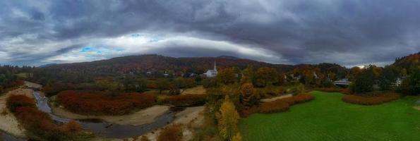 Stowe panorama in Autumn with colorful foliage and community church in Vermont. photo