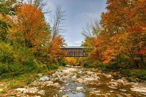 Grist Mill Covered Bridge in Cambridge, Vermont during fall foliage. photo