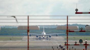 Passenger four engine wide body aircraft taxiing to the terminal after landing in Dusseldor video