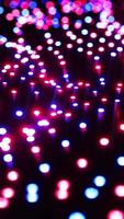 Multicolored LEDs moving in waves. Vertical looped video