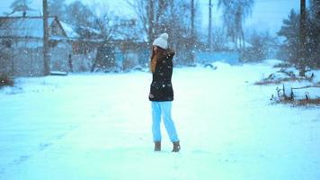 Cute girl in winter walks outside alone video