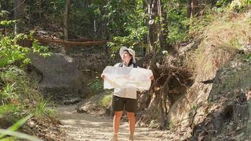 Female geologist using a map, examining a natural path and analyzing rocks or gravel. Researchers collect samples of biological materials. Environmental and ecology research. video