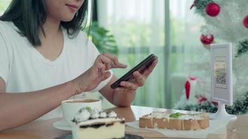 Woman use smartphone to scan QR code to pay in cafe restaurant with a digital payment without cash. Choose menu and order accumulate discount. E wallet, technology, pay online, credit card, bank app video