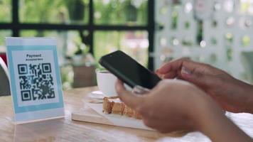 Woman use smartphone to scan QR code to pay in cafe restaurant with a digital payment without cash. Choose menu and order accumulate discount. E wallet, technology, pay online, credit card, bank app video