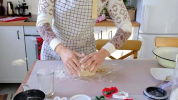 Mom and daughter in the white kitchen are preparing cookies for Christmas and new year. Family day, preparation for the holiday, learn to cook delicious pastries, cut shapes out of dough with molds video