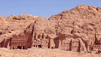 Top view tourist visit sightseeing Royal tombs structures in ancient city of Petra, Jordan. It is know as the Loculi. Petra has led to its designation as UNESCO World Heritage Site video
