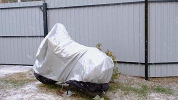 Motorcycle storage under an awning in winter outdoor. Protective awning, under the snow video